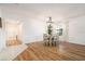 Bright dining room featuring wood floors, a modern chandelier, and natural light at 14330 Fissore Blvd, Wimauma, FL 33598