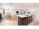 Open kitchen with a large island that looks into the living and dining room areas at 14330 Fissore Blvd, Wimauma, FL 33598