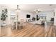 Open-concept living space with wood floors, dining area, and sliding glass doors at 14330 Fissore Blvd, Wimauma, FL 33598