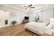 Bedroom featuring a tray ceiling, curtains and wood-look flooring at 14330 Fissore Blvd, Wimauma, FL 33598
