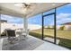 Screened lanai with dining set and a view of the spacious, well-maintained backyard at 14330 Fissore Blvd, Wimauma, FL 33598