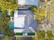 Aerial view of property showcasing the home's metal roof, manicured lawn, and refreshing backyard swimming pool at 1468 Plateau Rd, Clearwater, FL 33755