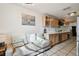 Kitchen nook featuring a small sofa and a partial view of the kitchen with natural wood cabinets at 1468 Plateau Rd, Clearwater, FL 33755