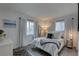 Bright bedroom with natural light from two windows, featuring a queen bed and modern decor at 1546 Pleasant Rd # J1, Bradenton, FL 34207