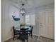 Intimate dining space with black table, comfortable chairs and a decorative nautical wall hanging at 1546 Pleasant Rd # J1, Bradenton, FL 34207