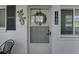 Close-up of the entrance, showcasing the door, house number, and decorative lizard wall art at 1546 Pleasant Rd # J1, Bradenton, FL 34207