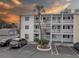 Condo building exterior with balconies, palm tree and parking spots at 1546 Pleasant Rd # J1, Bradenton, FL 34207