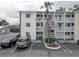 Front exterior view of condo building with stairway, balconies and parking at 1546 Pleasant Rd # J1, Bradenton, FL 34207