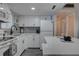 Bright kitchen featuring white cabinets, stainless appliances, and quartz countertops with integrated breakfast bar at 1546 Pleasant Rd # J1, Bradenton, FL 34207