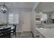 View of the kitchen with stainless appliances, white cabinets, and a dining area visible in the background at 1546 Pleasant Rd # J1, Bradenton, FL 34207