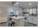 Contemporary kitchen featuring stainless appliances, white cabinets, and a breakfast bar overlooking the dining area at 1546 Pleasant Rd # J1, Bradenton, FL 34207