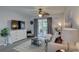 Relaxing living room featuring a ceiling fan, sliding glass doors, and comfortable seating arrangements at 1546 Pleasant Rd # J1, Bradenton, FL 34207