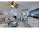 Open-concept living room featuring a ceiling fan, dining area, and breakfast bar with seating at 1546 Pleasant Rd # J1, Bradenton, FL 34207