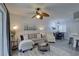 Inviting living room space featuring a ceiling fan and an open dining area, perfect for entertaining at 1546 Pleasant Rd # J1, Bradenton, FL 34207