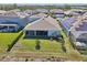 A nice aerial view of the home highlighting a large back yard, screened patio, and proximity to other well-kept properties at 16407 Frehley Run, Land O Lakes, FL 34638
