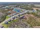 A picturesque aerial view of the neighborhood showcasing well-placed homes amidst lush greenery and scenic ponds at 16407 Frehley Run, Land O Lakes, FL 34638