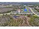 A wide angle aerial view of the neighborhood and community highlighting the serene nature preserve and pond nearby at 16407 Frehley Run, Land O Lakes, FL 34638