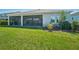 Expansive backyard featuring a screened lanai, lush lawn, and well-maintained landscaping for outdoor enjoyment at 16407 Frehley Run, Land O Lakes, FL 34638