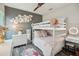Charming bedroom with bunk beds, flower decorations, and a white dresser at 16407 Frehley Run, Land O Lakes, FL 34638