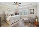 Comfortable bedroom with natural light, chair, and stylish decor at 16407 Frehley Run, Land O Lakes, FL 34638