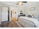 Spacious main bedroom with a decorative ceiling fan, walk-in closet and wood floors at 16407 Frehley Run, Land O Lakes, FL 34638