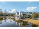 Exterior of community building on the water with views of the lake and surrounding trees at 16407 Frehley Run, Land O Lakes, FL 34638