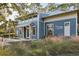 Exterior of the fitness center featuring a blue exterior with lush landscaping at 16407 Frehley Run, Land O Lakes, FL 34638