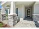 Inviting front entrance features stone accents and a covered walkway to the front door at 16407 Frehley Run, Land O Lakes, FL 34638