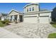 Charming home boasts three-car garage, decorative stone accents, and a beautifully paved driveway at 16407 Frehley Run, Land O Lakes, FL 34638