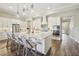 Modern kitchen features stainless steel appliances and a large central island with barstool seating at 16407 Frehley Run, Land O Lakes, FL 34638