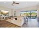 Bright living room boasts an oversized sectional and wall of sliding glass doors to enjoy the outdoors at 16407 Frehley Run, Land O Lakes, FL 34638