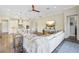 Bright living room with open kitchen layout, featuring a large sectional and modern decor at 16407 Frehley Run, Land O Lakes, FL 34638