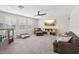 Spacious living room with carpet, a ceiling fan, big windows, and a TV at 16407 Frehley Run, Land O Lakes, FL 34638
