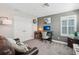 Office with white walls, an office desk, a decorative chair, and a brown leather sofa at 16407 Frehley Run, Land O Lakes, FL 34638
