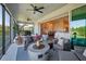 Covered patio with seating area, ceiling fans, and a view to the dining room and kitchen at 16407 Frehley Run, Land O Lakes, FL 34638