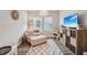 Cozy playroom features a soft chair and ottoman, storage, and natural light, ideal for children at 16407 Frehley Run, Land O Lakes, FL 34638