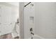 Modern shower with white subway tile, bronze fixtures, and niche shelving at 16407 Frehley Run, Land O Lakes, FL 34638