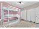 Bright bedroom features a triple bunk bed, light gray floors, and two large closets at 17108 Carrington Park Dr # 701, Tampa, FL 33647