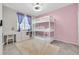 This bright bedroom boasts a triple bunk bed, a desk, and a large window for natural light at 17108 Carrington Park Dr # 701, Tampa, FL 33647