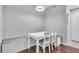 Cozy dining area with white table, chairs, and built-in bench seating under a modern light fixture at 17108 Carrington Park Dr # 701, Tampa, FL 33647