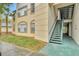 The exterior of a condo building featuring stairs, greenery, and multiple windows at 17108 Carrington Park Dr # 701, Tampa, FL 33647