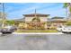 Community clubhouse featuring manicured landscaping with colorful flowers and parking for guests at 17108 Carrington Park Dr # 701, Tampa, FL 33647