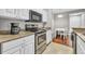 Updated kitchen featuring granite countertops, stainless steel appliances and white cabinets at 17108 Carrington Park Dr # 701, Tampa, FL 33647