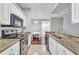 Updated kitchen featuring granite countertops, stainless steel appliances and white cabinets at 17108 Carrington Park Dr # 701, Tampa, FL 33647