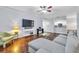 Open concept living room featuring hardwood floors, ceiling fan, and large windows at 17108 Carrington Park Dr # 701, Tampa, FL 33647