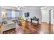 Spacious living room with hardwood floors, ceiling fan, and large windows at 17108 Carrington Park Dr # 701, Tampa, FL 33647