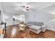 Spacious living room featuring hardwood floors, ceiling fan, and an open layout at 17108 Carrington Park Dr # 701, Tampa, FL 33647