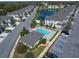 Overhead view of townhomes with a community pool, clubhouse, and nearby parking at 1986 Lake Ridge Blvd, Clearwater, FL 33763