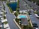 Scenic aerial view of townhomes, a tranquil lake, and a sparkling pool at 1986 Lake Ridge Blvd, Clearwater, FL 33763