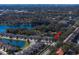 Aerial view of townhomes nestled by a serene lake offering a picturesque community setting. Arrow shows subject home at 1986 Lake Ridge Blvd, Clearwater, FL 33763